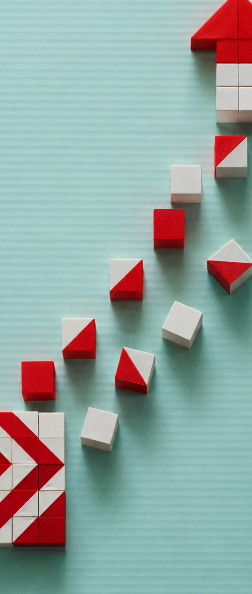 Red and white geometric blocks forming an upward growth path