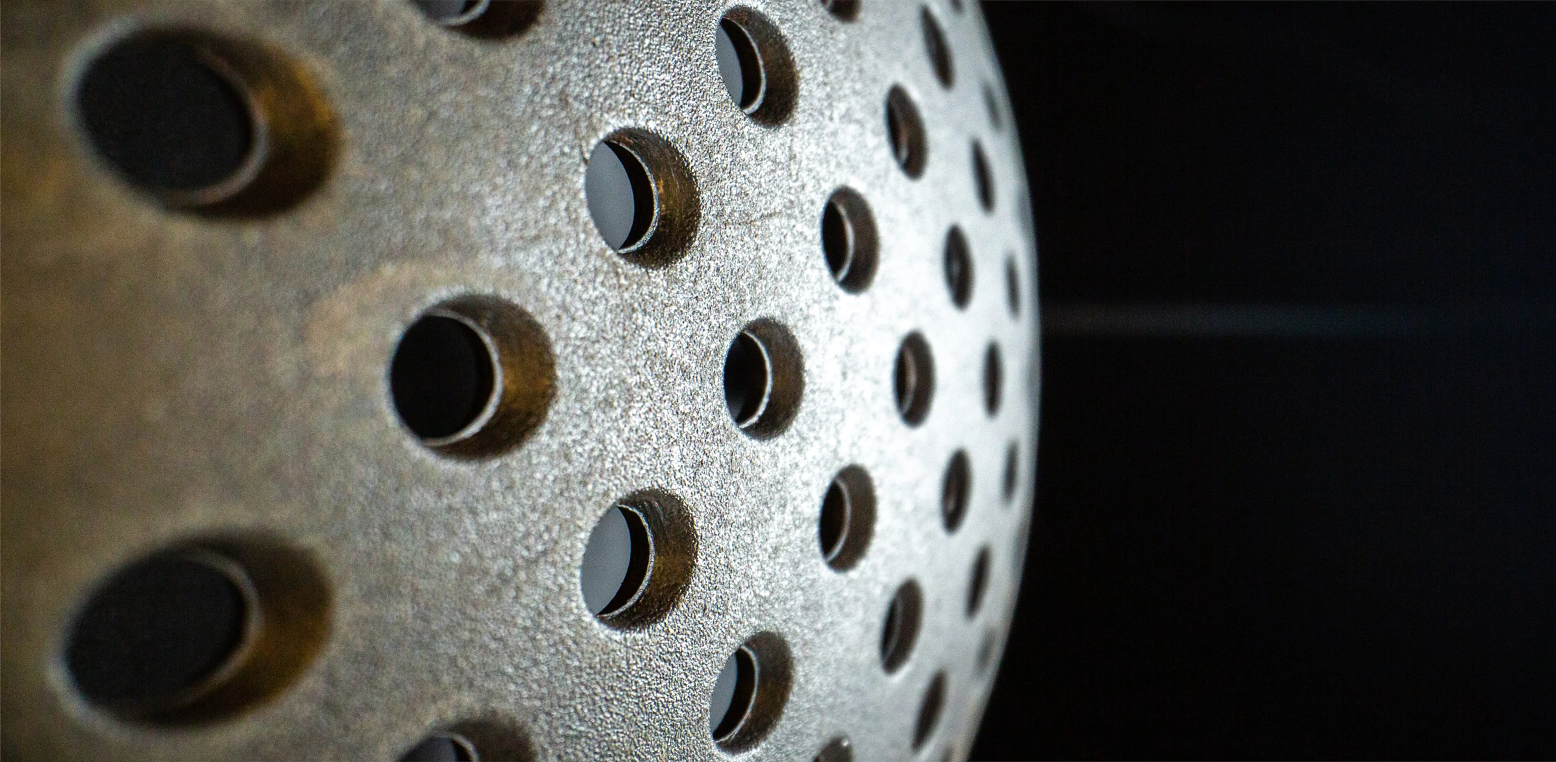 Close-up of a dark industrial component used as the grow section background